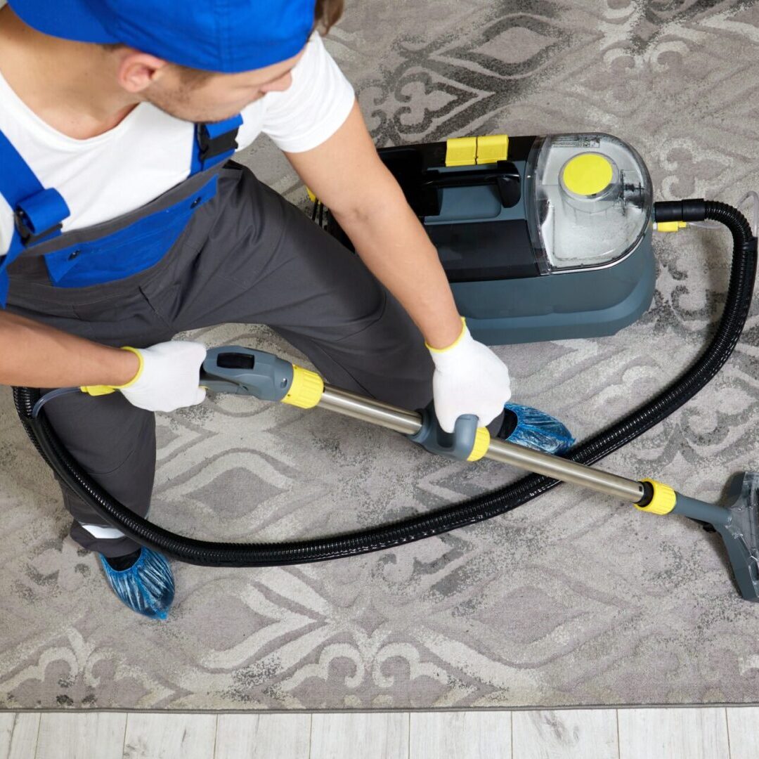 Carpet cleaning technician vacuuming patterned rug in Phoenix Arizona